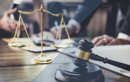 legal team out of focus behind a gavel